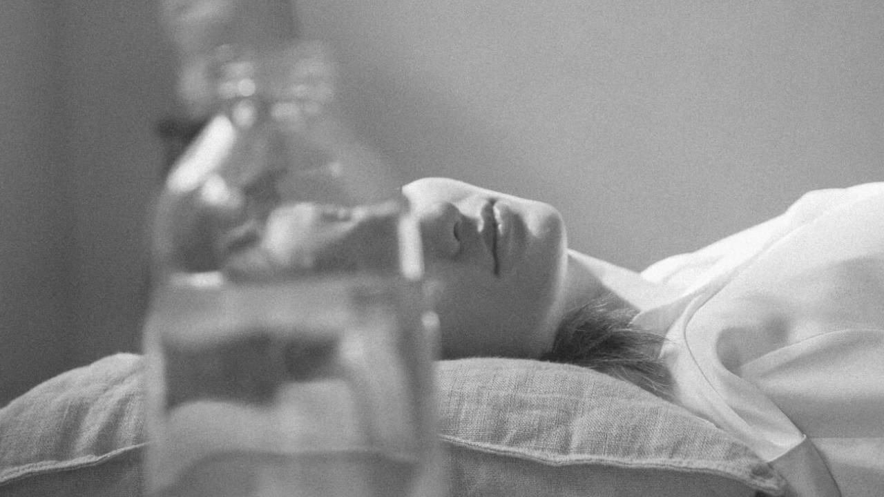 Person resting in bed, shot in black and white